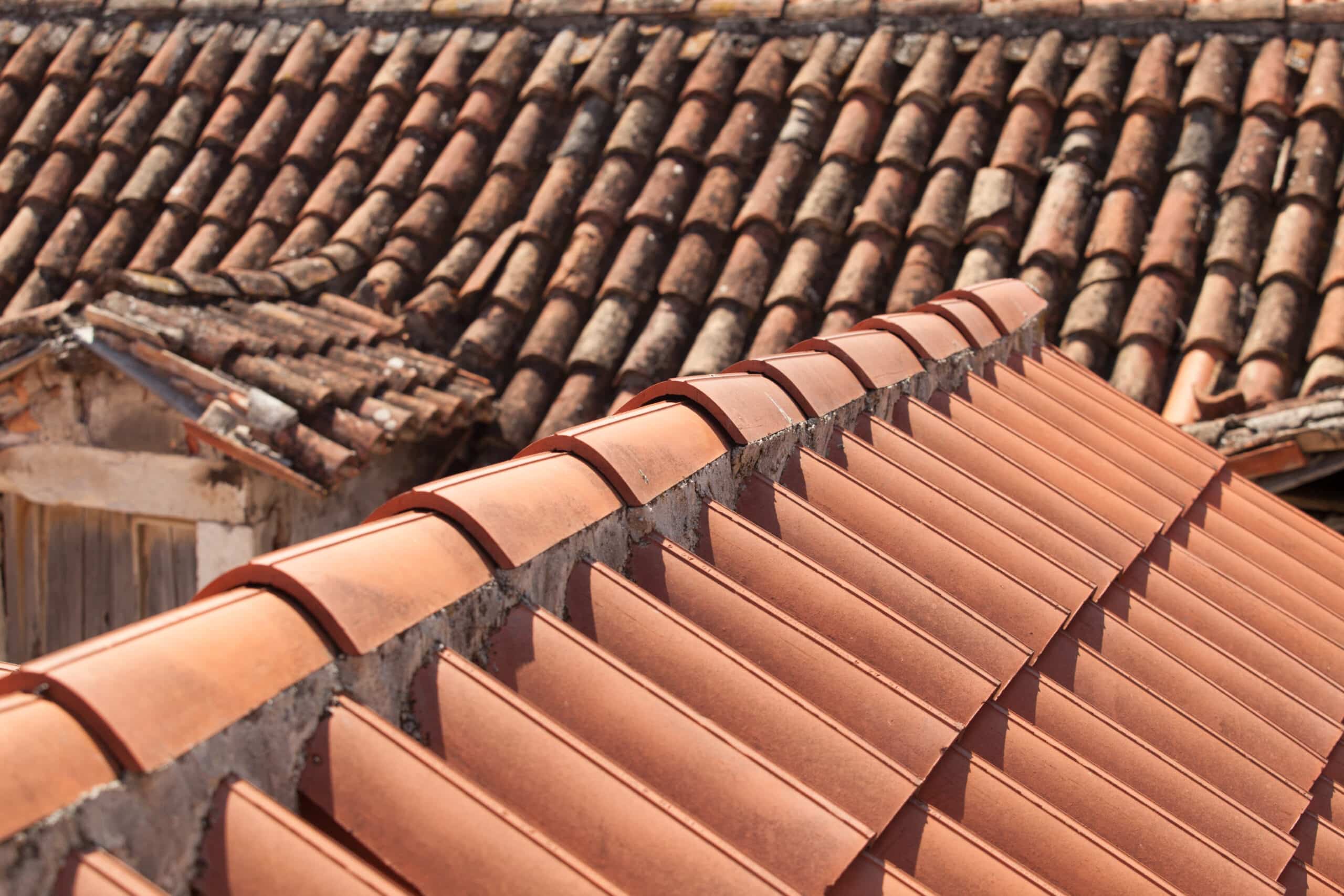 The old and new traditional red terracotta roofs with curved tiles
